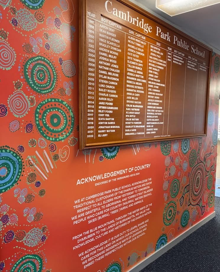 honour board with mural background